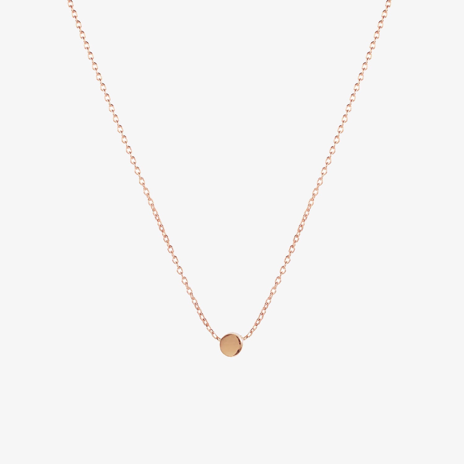 Simple rose gold dot necklace by Matthew Calvin on a white background