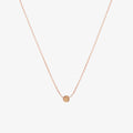 Simple rose gold dot necklace by Matthew Calvin on a white background
