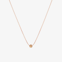 Simple rose gold dot necklace by Matthew Calvin on a white background