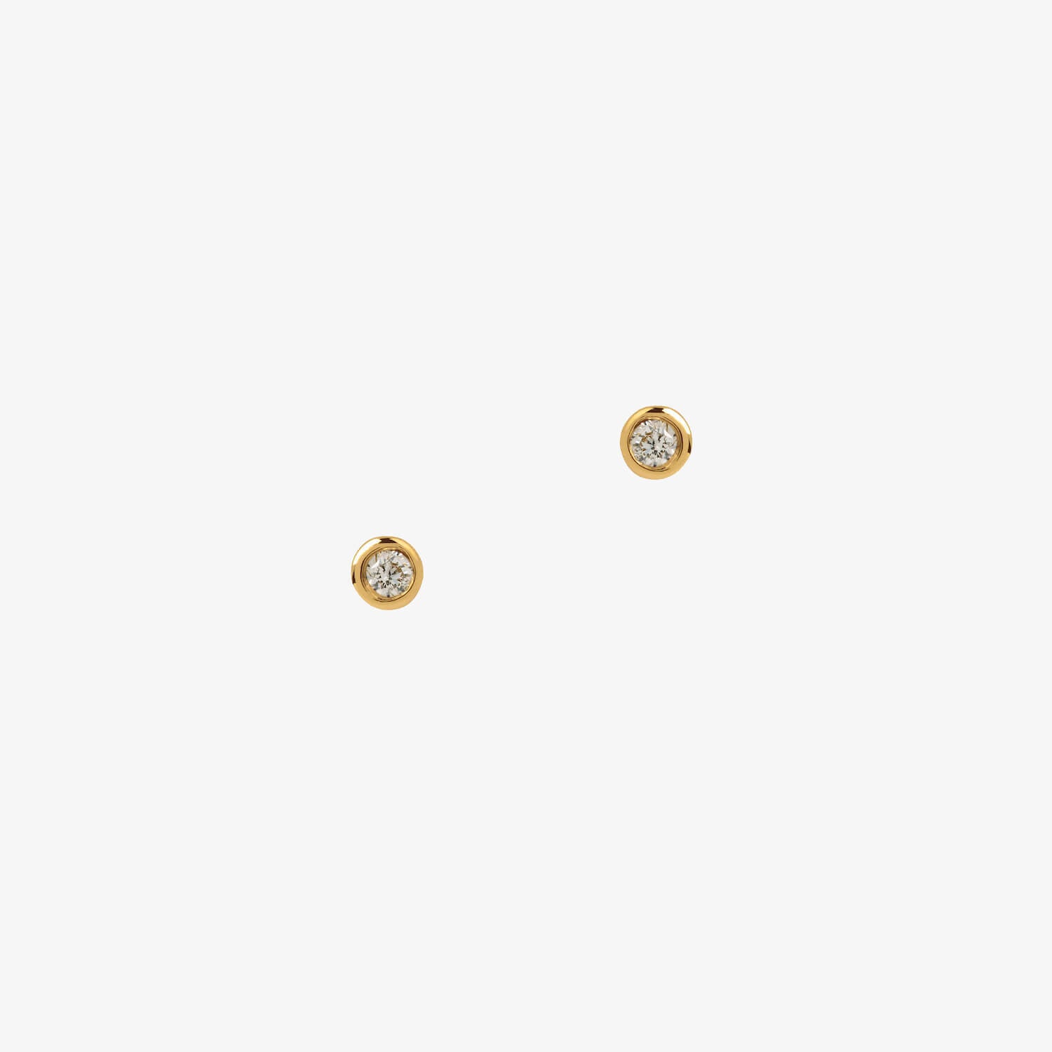 Matthew calvin gold diamond tiny tube studs on a white background