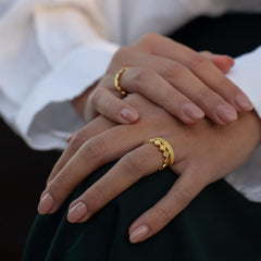 Lifestyle image of model wearing Matthew Calvin gold rings