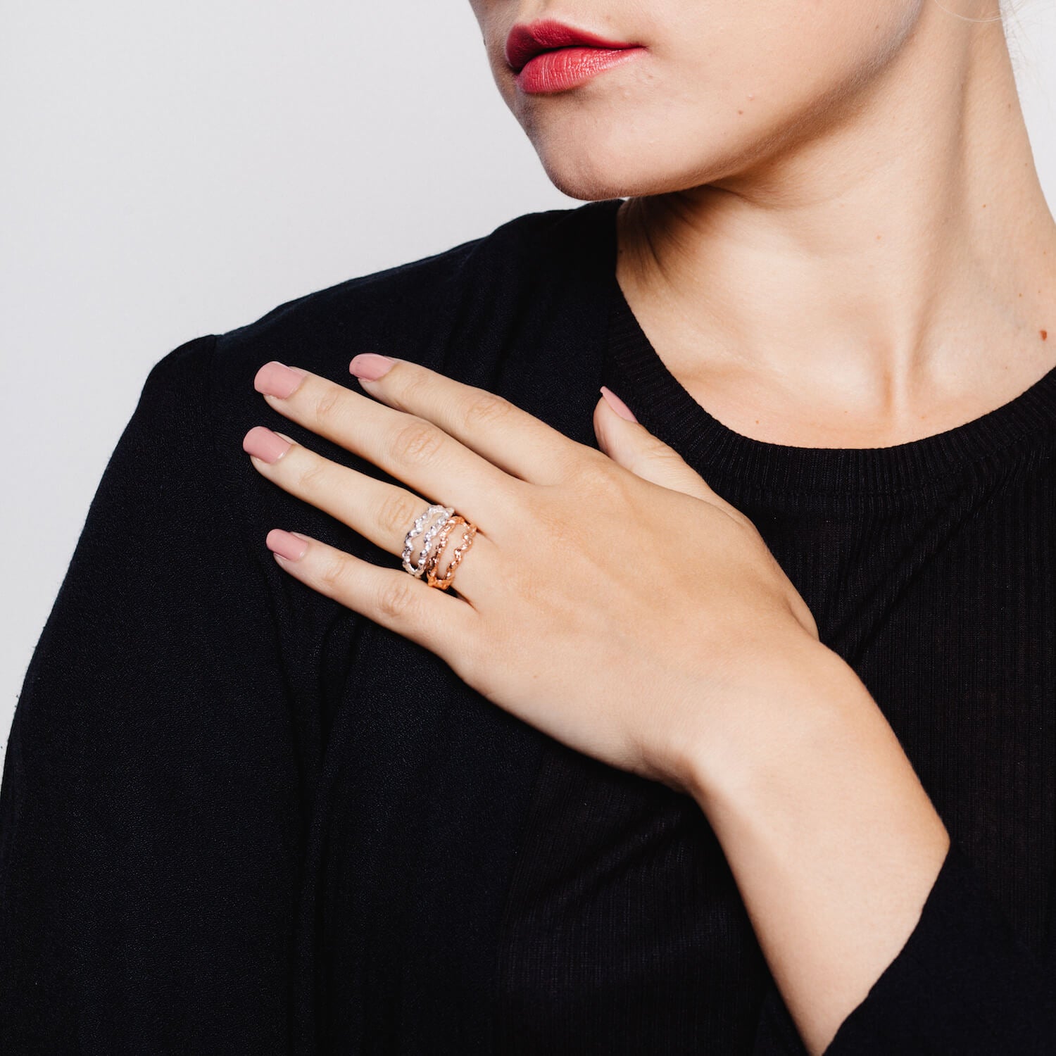 Woman wearing two interesting double band rings with carved details