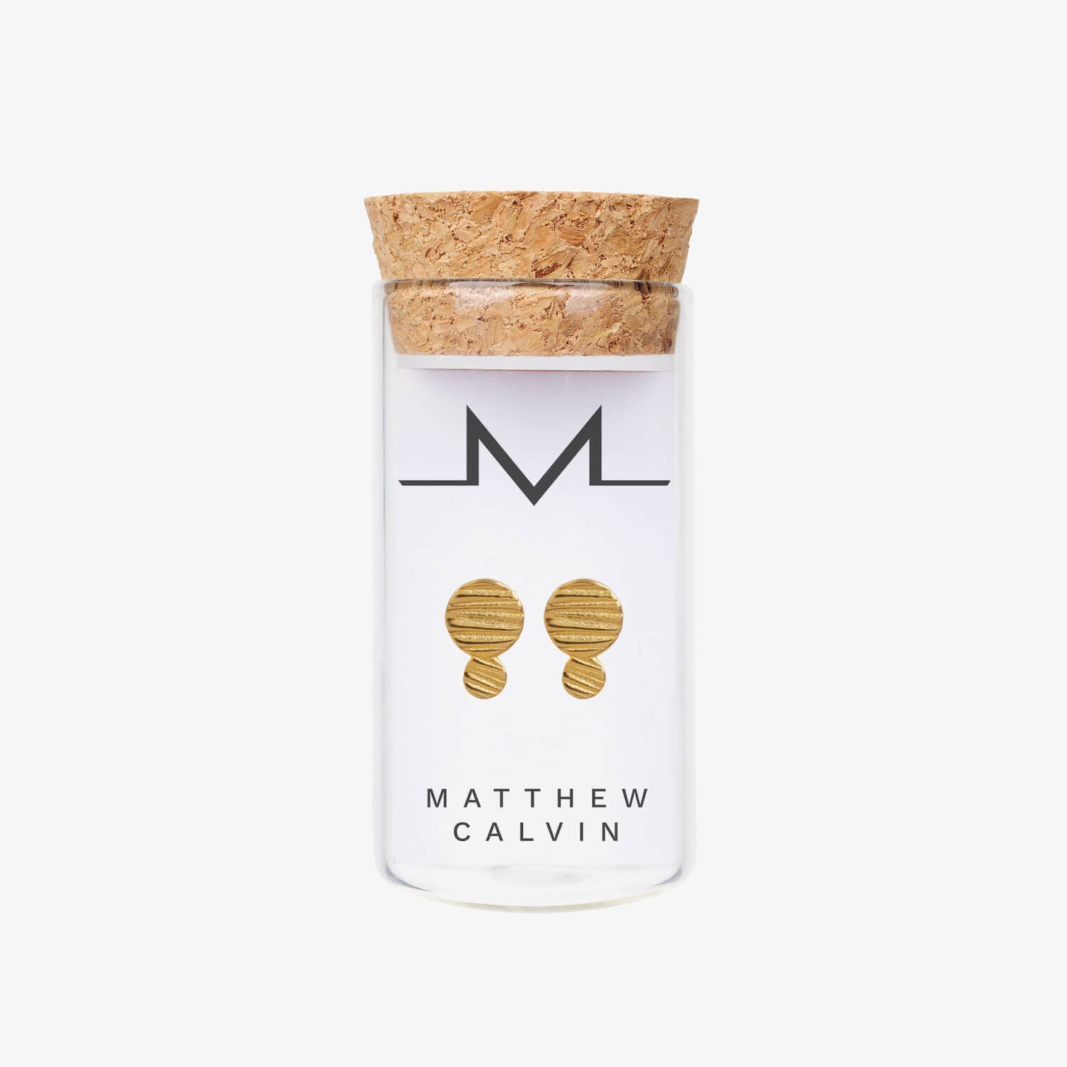 Stud earrings in a glass bottle with a cork lid