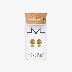 Stud earrings in a glass bottle with a cork lid