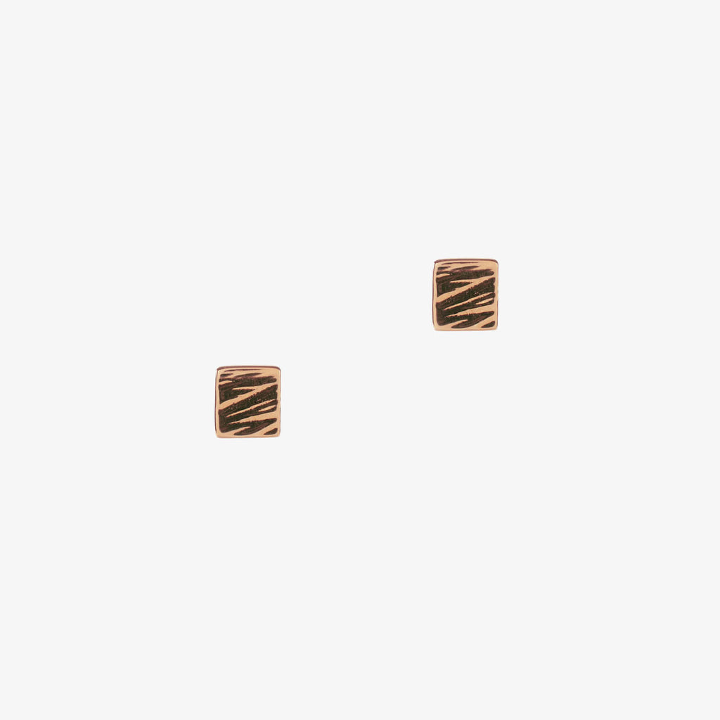 Small square studs in rose gold with a textured detail