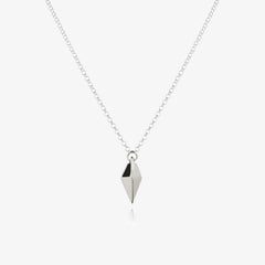 Silver necklace with a kite shaped charm on a white background