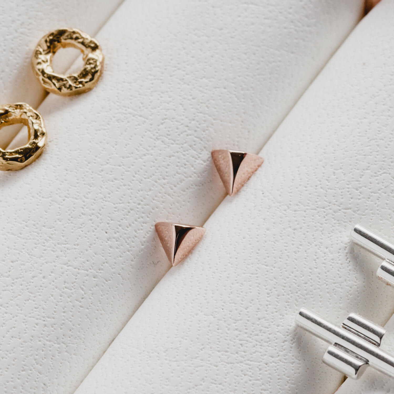 Rose gold geometric earrings in a jewellery holder