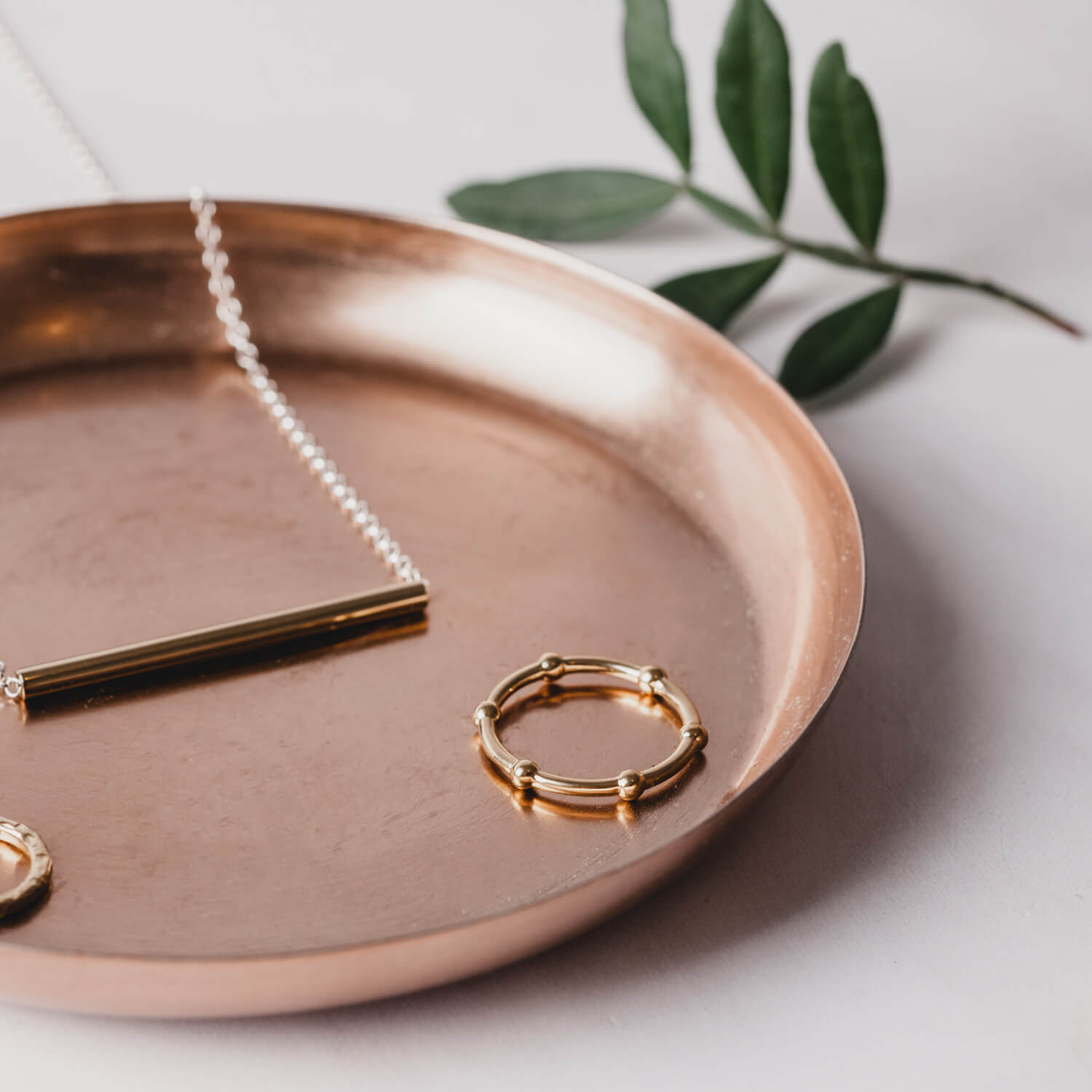 A rose gold ring made from beaded wire on a rose gold plate