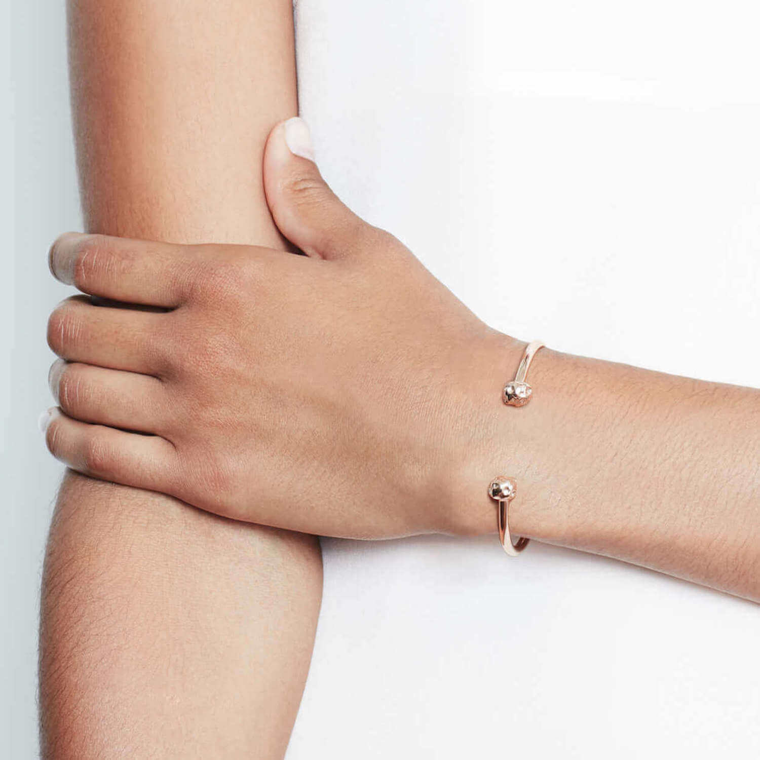 Model wearing double meteorite bangle with textured charms