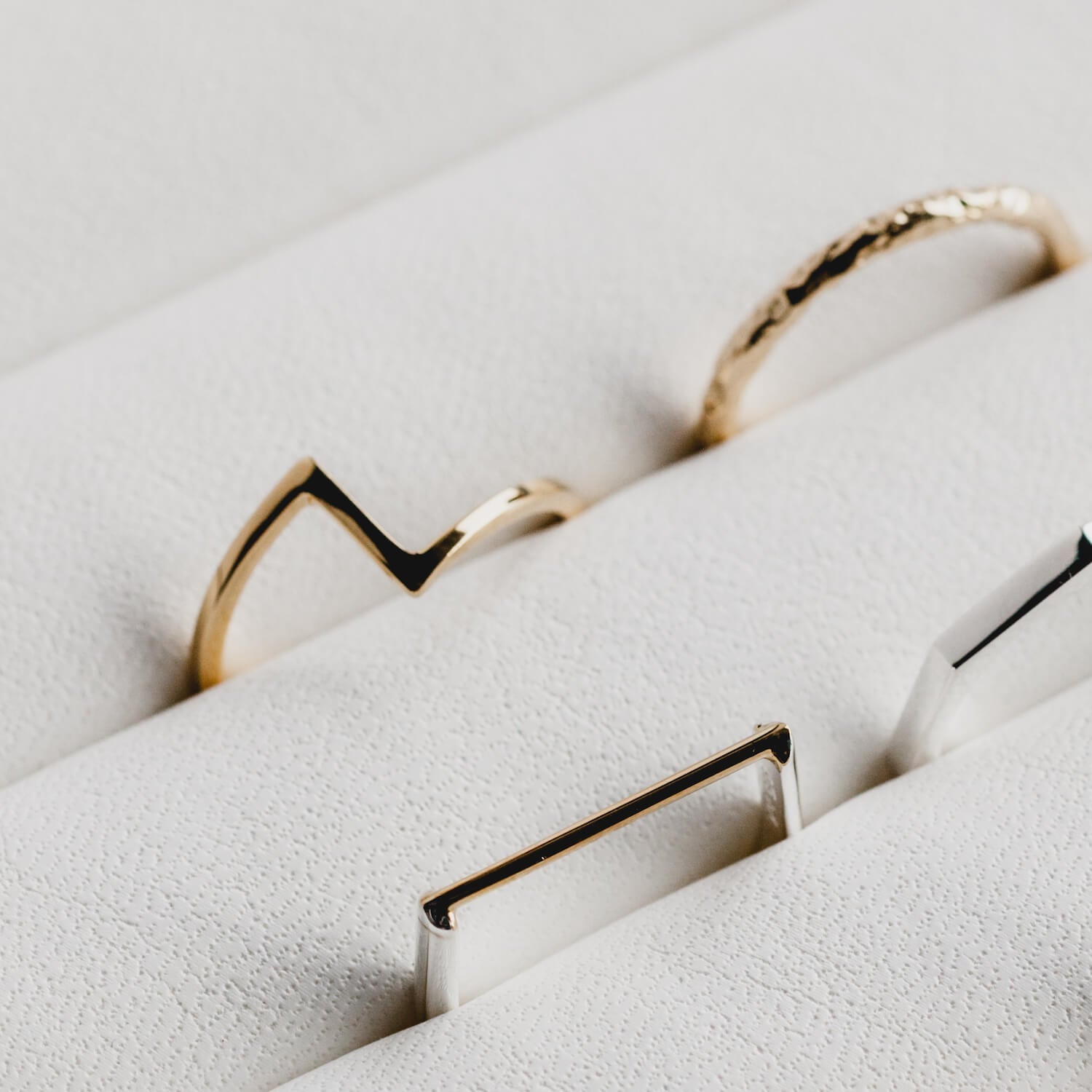 Close up picture of rings in a white ring tray, matthew calvin joint ring is the focus