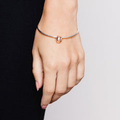 Model wearing meteorite bangle with rose gold textured charm