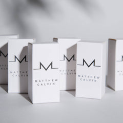 White boxes with Matthew Calvin and M logo written on them in black