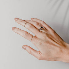Close up of a woman's hand wearing multiple Matthew Calvin rings