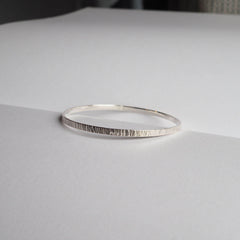 Silver textured bangle on a table