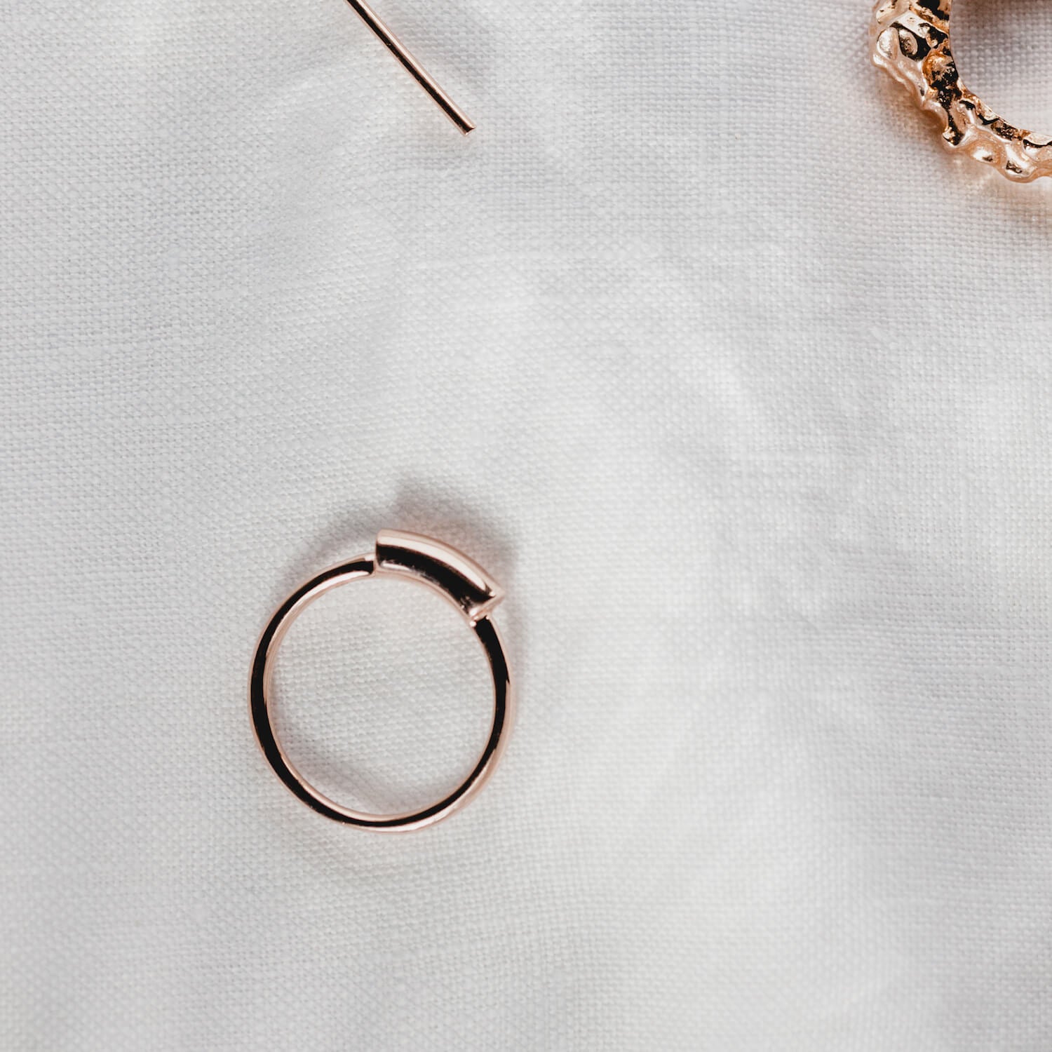 A rose gold ring with a thick wire signet style detail