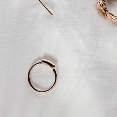 Close up of rose gold ring with thick wire signet detail