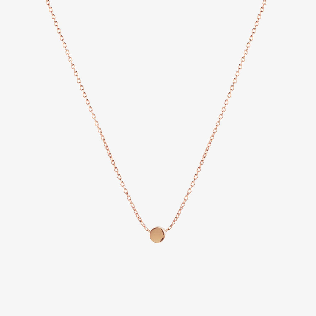 Simple rose gold dot necklace by Matthew Calvin on a white background
