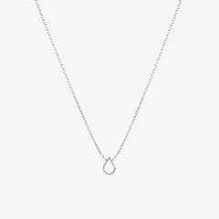 A silver necklace with a teardrop shaped charm on a white background