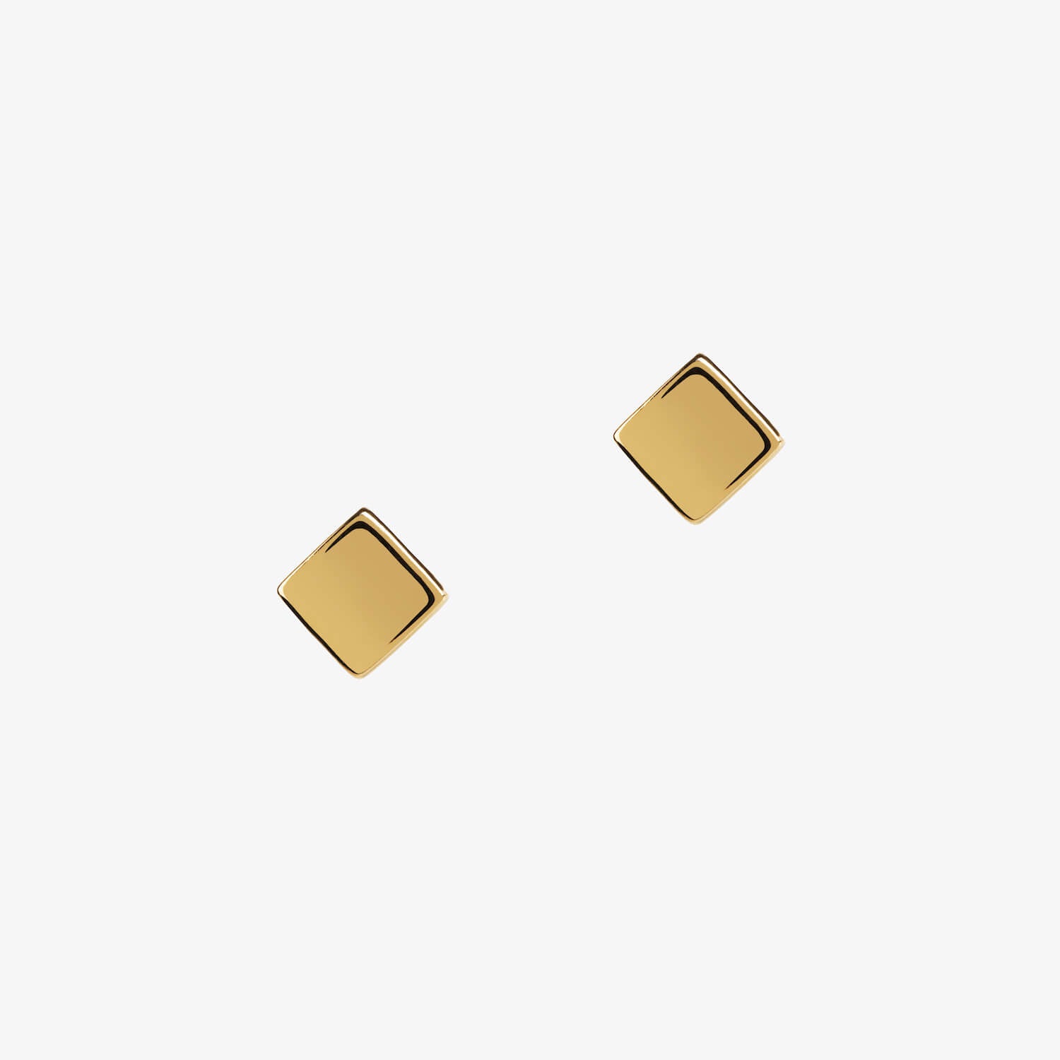 gold vermeil cube square stud earrings by matthew calvin on a white background
