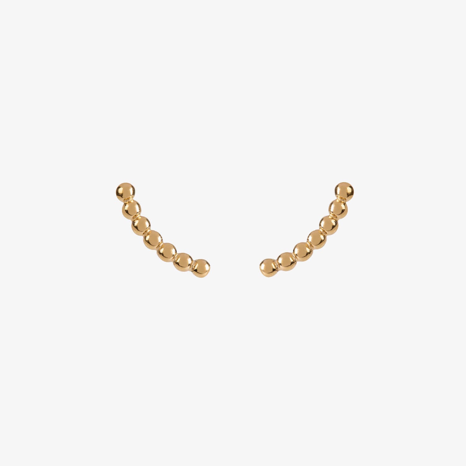 gold curved beaded ear climber stud earrings by matthew calvin on a white background
