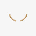 gold curved beaded ear climber stud earrings by matthew calvin on a white background