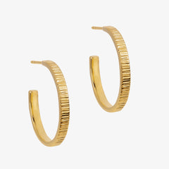 Close up of gold hoop earrings with texturing detail