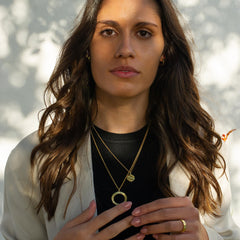A model wearing two gold necklaces