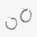 Product photography with silver textured hoops by Matthew Calvin