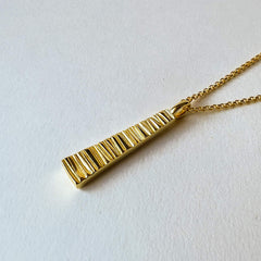 Close up of Doru Tapered Necklace in gold with belcher chain