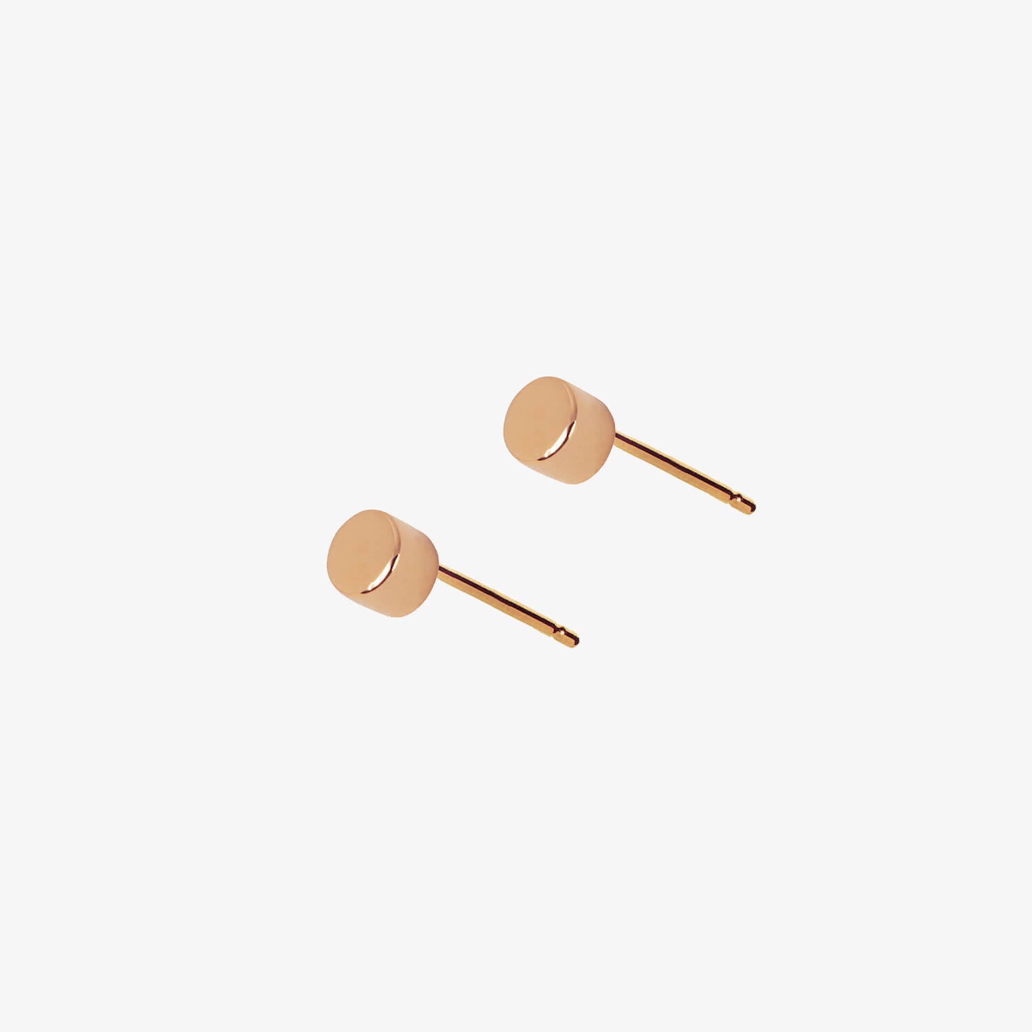 Simple rose gold dot stud earrings by Matthew Calvin on a white background