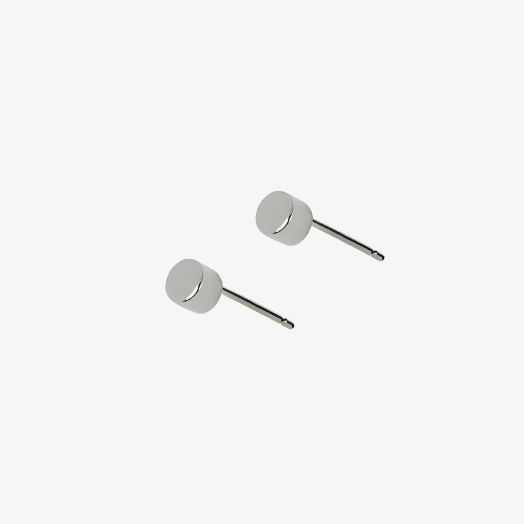 Simple sterling silver dot stud earrings by Matthew Calvin on a white background