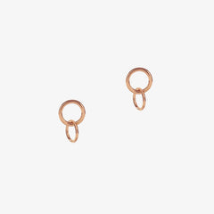 Rose gold studs with interlocking ring detail on a white background