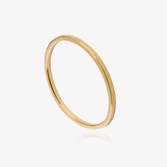 Gold textured ring on a white background