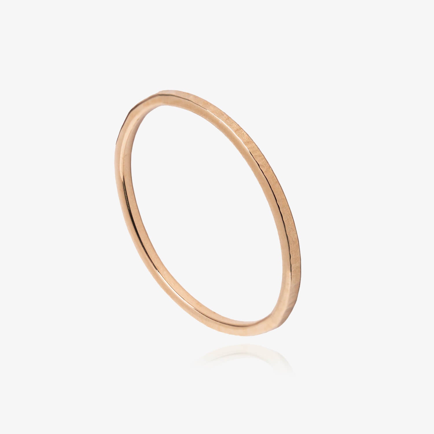 Rose gold textured ring on a white background