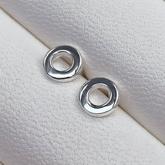 sterling silver loop circular earrings by matthew calvin photographed in a white jewellery box close up