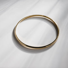 Gold bangle on a white background