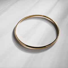 Close up of a bangle on a plain marble background