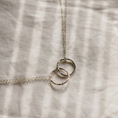 Silver pendant with two linked rings by Matthew Calvin Jewellery