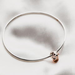 Close up of meteorite bangle with textured charm