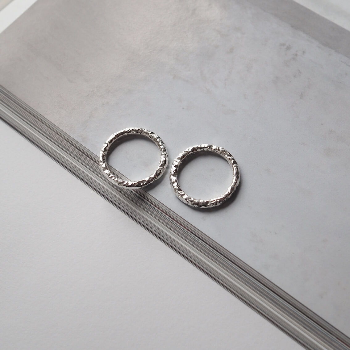 Two silver textured rings on magazine