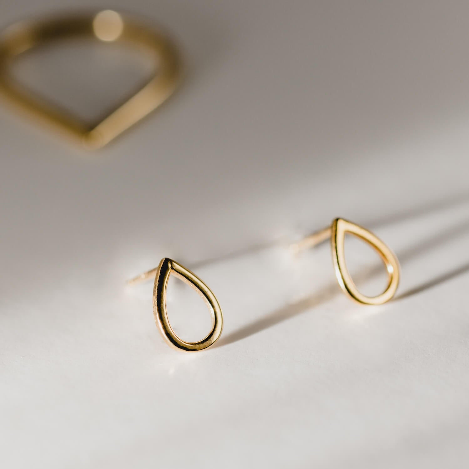 Close up of gold droplet earrings