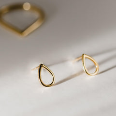 Close up of gold droplet earrings