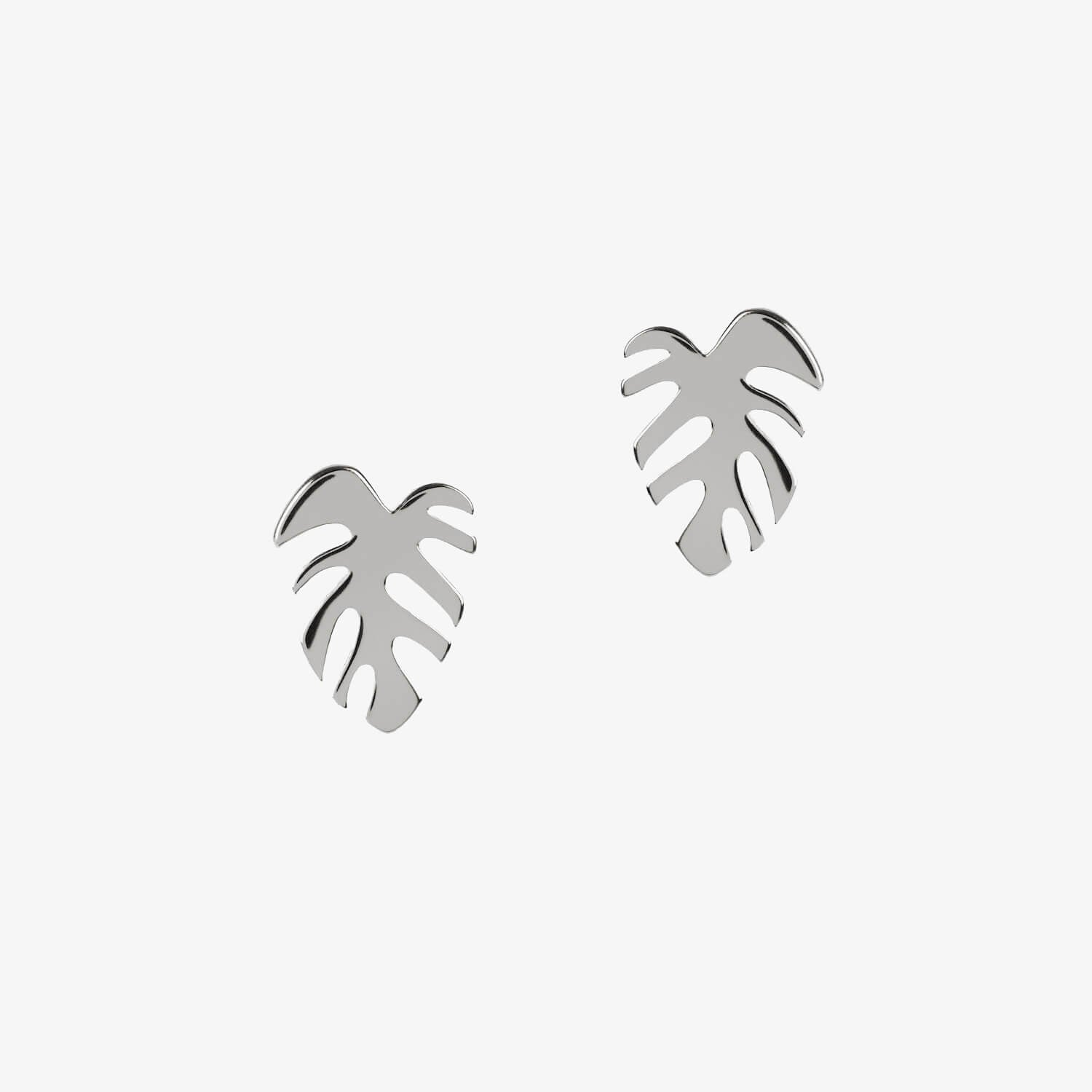 silver monstera leaf shaped earrings by matthew calvin on a white background