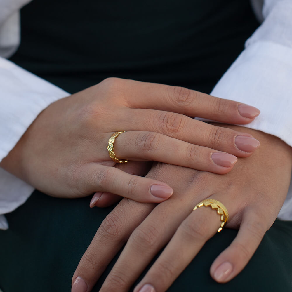 A model wearing several gold rings by Matthew Calvin Jewellery