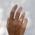 Two rings on a woman's hand with textured detail