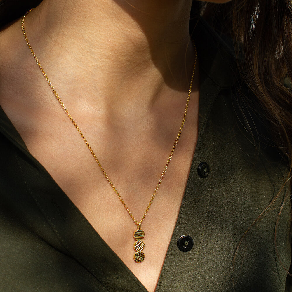 Model wearing Origins Trio Necklace by Matthew Calvin