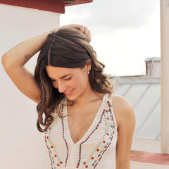 Woman on a sunny roof terrace wearing silver earrings