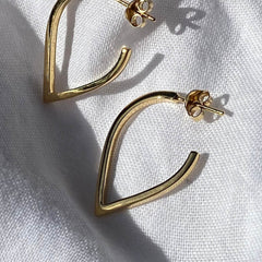 Close up of golds pointed hoops