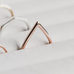 Close up of a rose gold Point Ring in a ring holder