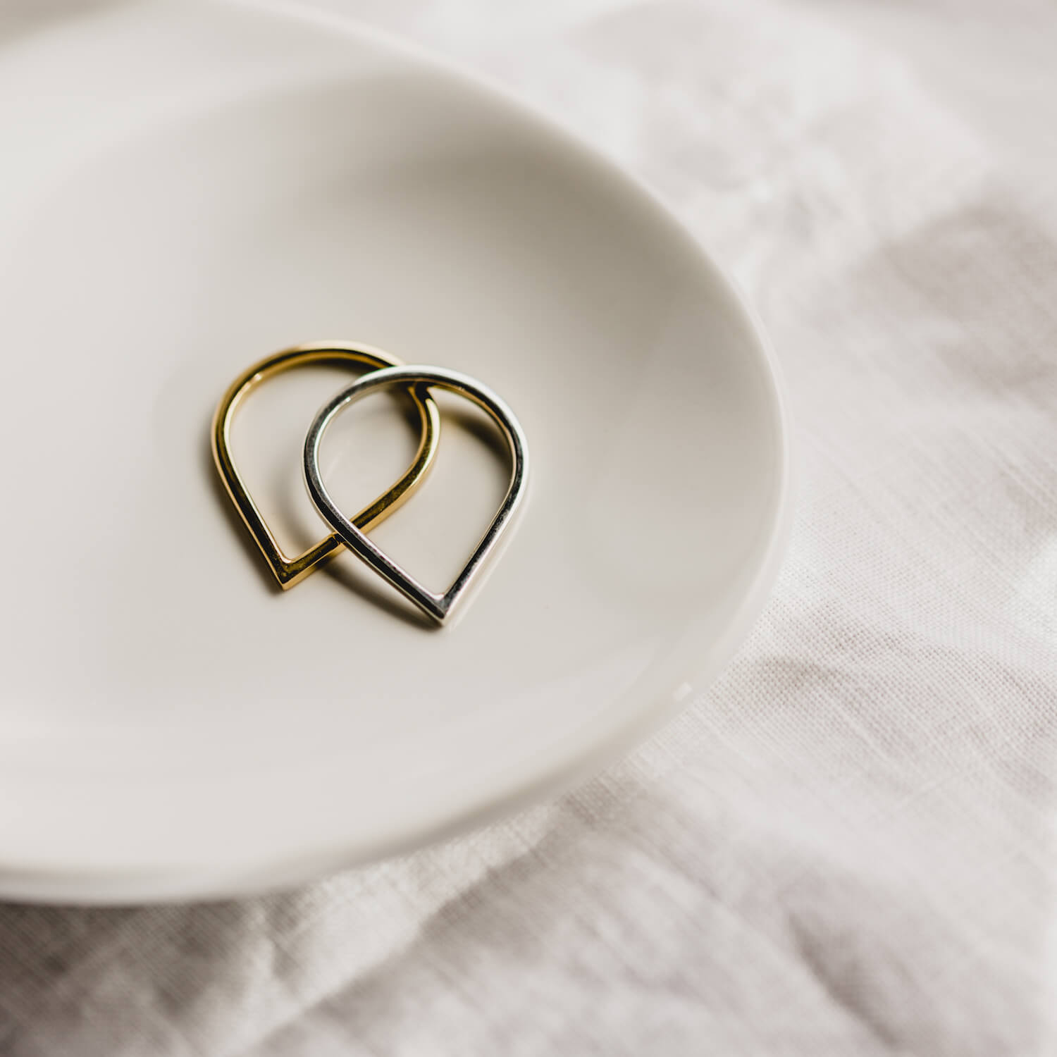 Close up of two Point Rings, one in silver and one in gold